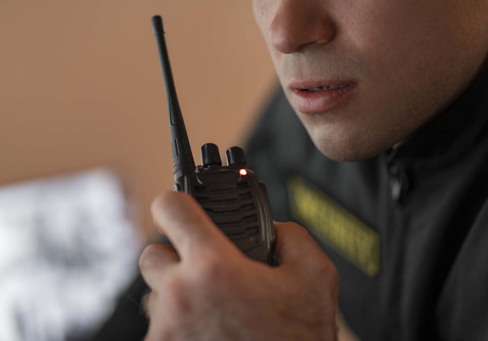 portrait-male-security-guard-with-radio-station-camera-screens (1)